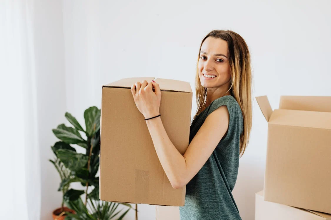 A woman holding onto a box in her hand