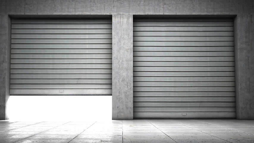 Two garage doors are closed on a concrete floor.